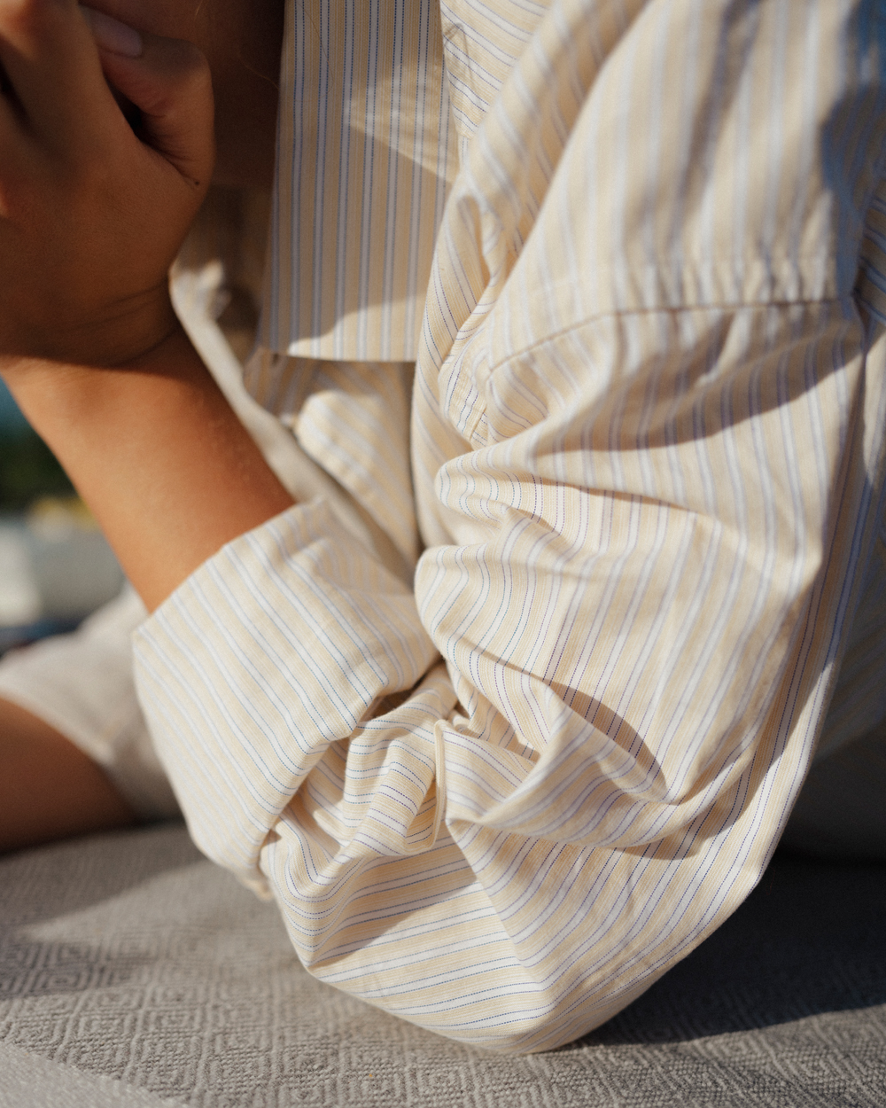 Striped shirt sleeve at sunset, photo by jeroen van de gruiter, 2021